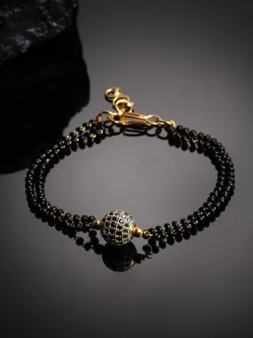 Gold-Plated Black Stone-Studded & Beaded Hand Mangalsutra Gold-Plated Black Stone-Studded & Beaded Hand Mangalsutra